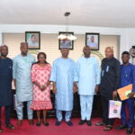 Members of the ID4D Delegation posing for a Photograph with the Executive Secretary, NCPWD, during the visit